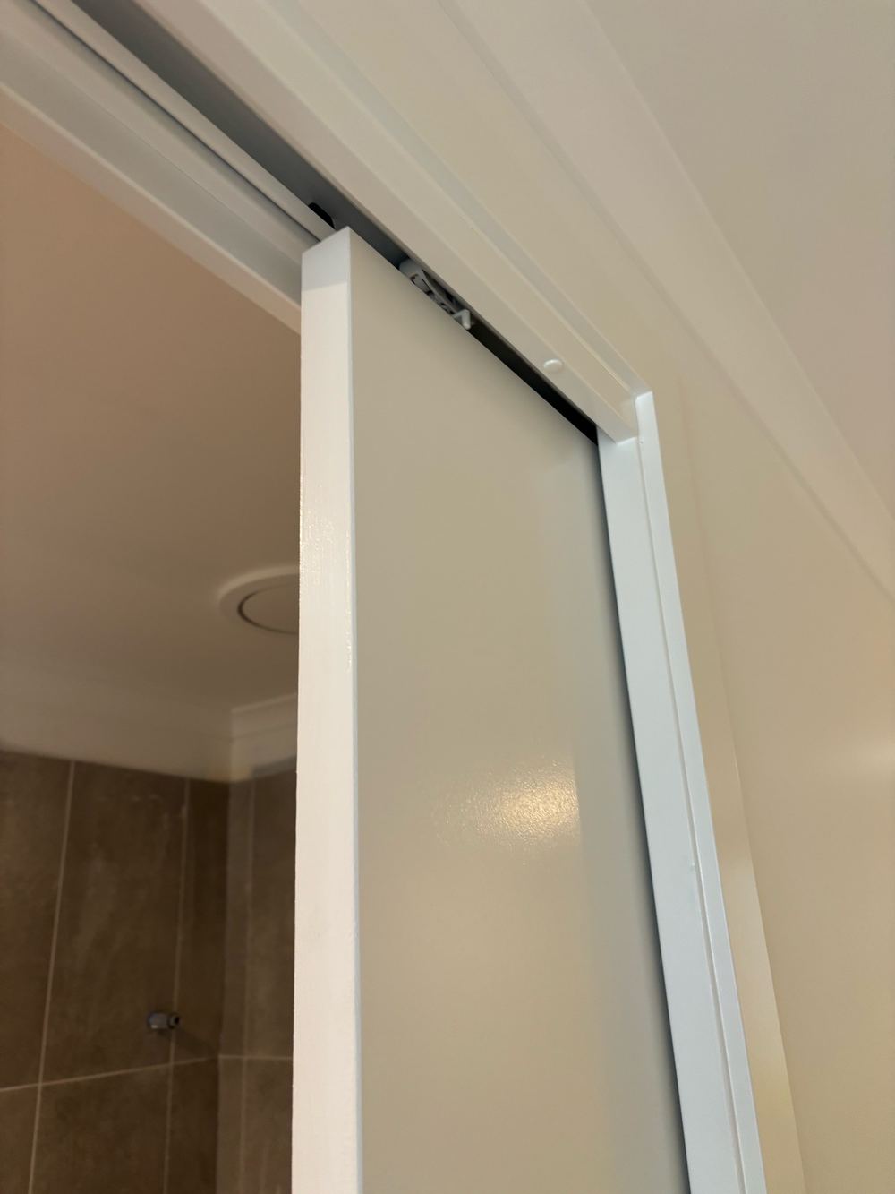 Cavity sliding door missing its guides, so the door rubs and scratches on the frame, found during a waterproofing inspection in Wollert