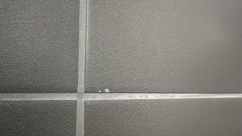 Cracked and chipped tiles that need replacing, found during a practical completion inspection in Wollert
