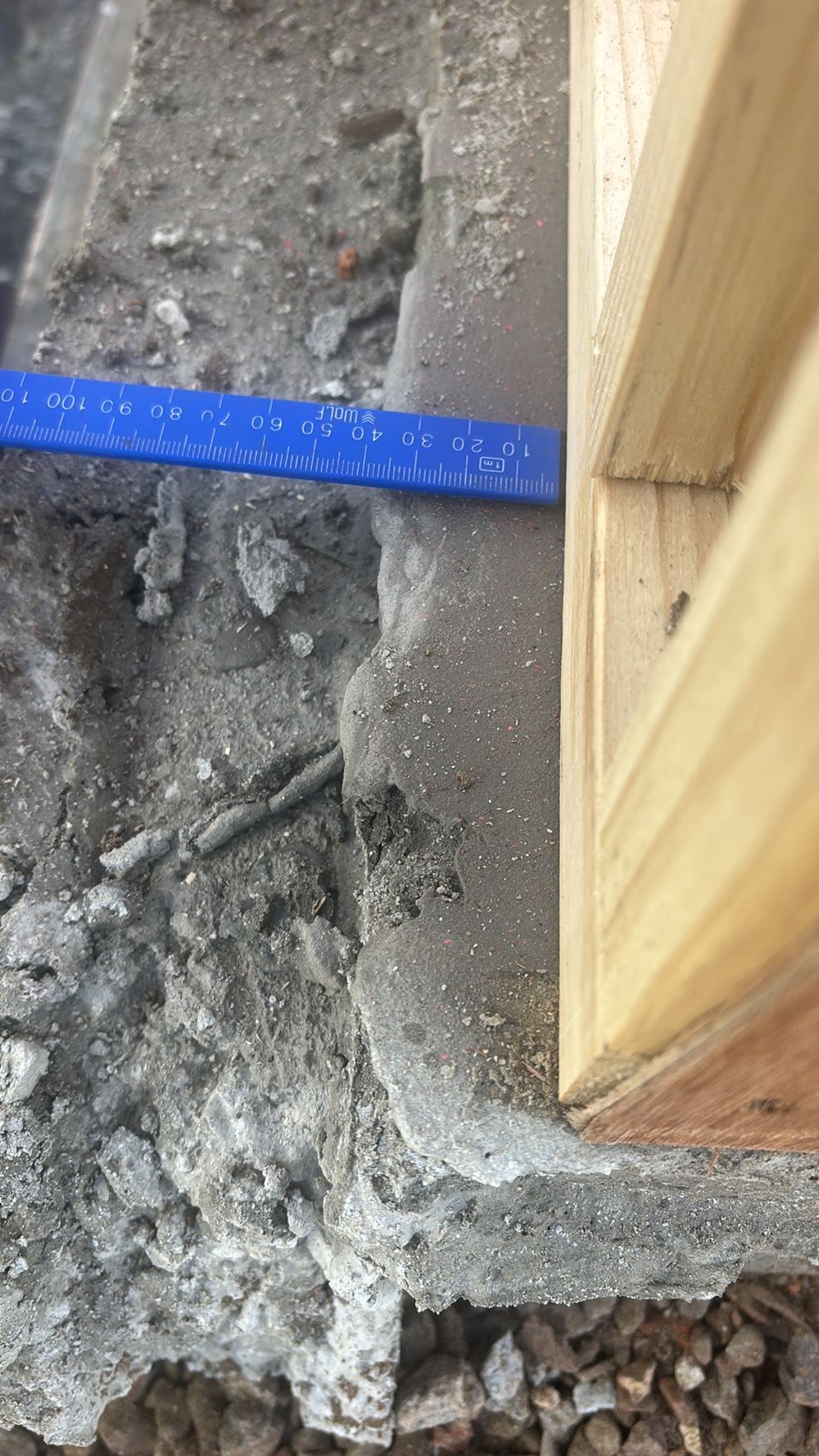 Slab sticking out past the timber frame by over 20mm, squeezing the brick cavity, found during a frame inspection in Wollert